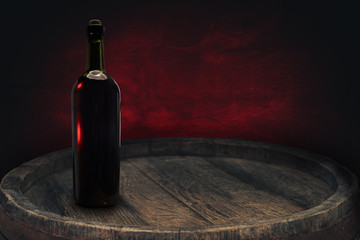 Red wine bottle on a old barrel table background wood wall.