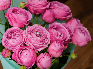 ring in a flower bouquet with pink roses