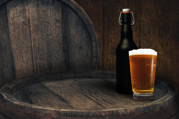 Wooden barrel and glass of beer on a old oak table of wood.