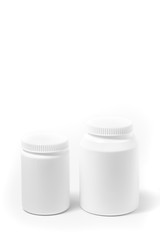 Two bottles of medicine white pills isolated on white