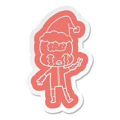 cartoon sticker of a big brain alien crying and giving peace sign wearing santa hat