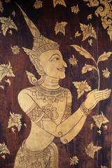 Angel guarding the entrance door in Wat Pong Sanuk Temple, Lampang, Thailand