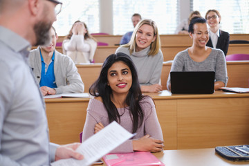 Obraz premium Lecturer and multinational group of students in an auditorium