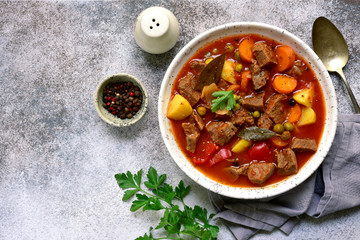 Meat stew with vegetables in tomato sauce.Top view with copy space.