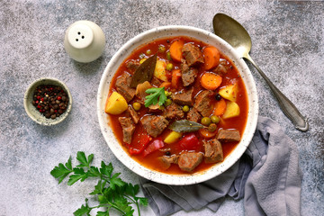 Meat stew with vegetables in tomato sauce.Top view with copy space.