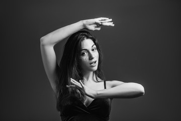 Beautiful young woman posing and acting. Inspiration and imagination. Female making frame gesture. Black and white.