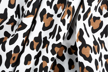 Cotton fabric with animal print. Animal pattern background or texture. Texture leopard. Black and...
