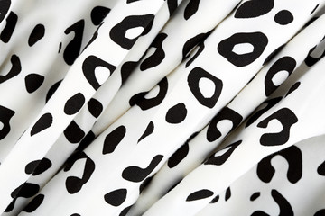 Cotton fabric with animal print. Animal pattern background or texture. Texture leopard. Black and white fabric.