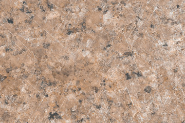 Texture of brown marble, polished natural surface, with signs of wear on the surface of the stone
