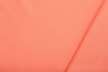 Fototapeta premium Pink cotton textile - close up of fabric texture. Cotton Fabric Texture. Top View of Cloth Textile Surface. Pink Clothing Background. Text Space. Abstract background and texture for designers.
