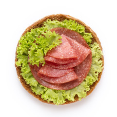 Sandwich with salami sausage on white background.