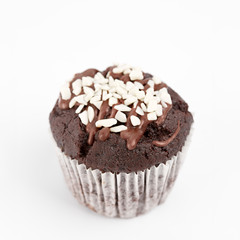 Tasty chocolate cupcakes on white background. Chocolate caramel cupcake and butterscotch syrup. Chocolate cupcake isolated on white.