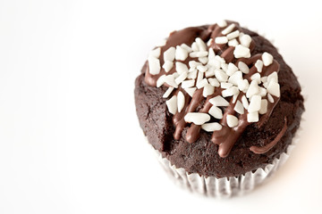 Tasty chocolate cupcakes on white background. Chocolate caramel cupcake and butterscotch syrup. Chocolate cupcake isolated on white.