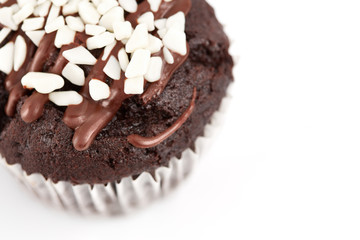 Tasty chocolate cupcakes on white background. Chocolate caramel cupcake and butterscotch syrup. Chocolate cupcake isolated on white.