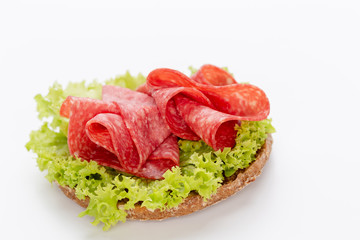 Sandwich with salami sausage on white background.