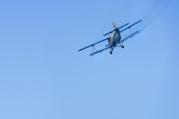 Airplane agricultural aircraft flying in the sky spraying mosquitoes