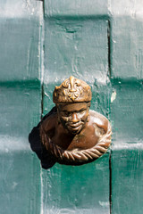 Ornament on a green door in Venice