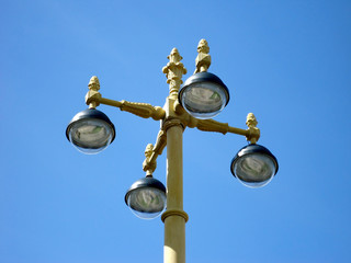 Old beautiful yellow lantern on a background of blue sky daytime summer park