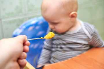 A boy with a closed mouth does not want to eat