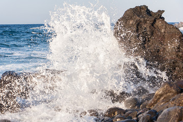 Waves breaking on the rocks. Water splash 