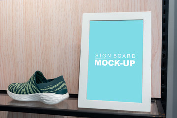 Mock up vertical signage in sport shoes shop