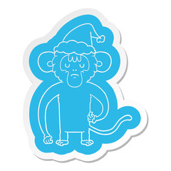 cartoon  sticker of a monkey scratching wearing santa hat