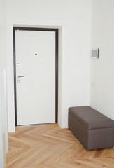 Modern house entrance metal door, corridor interior with  smart house system.