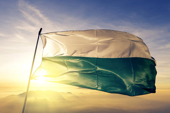 Pando department of Bolivia flag waving on the top sunrise mist fog