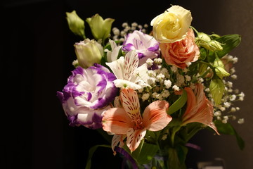 Beautiful wedding bouquet composed of different flowers on a black background.
