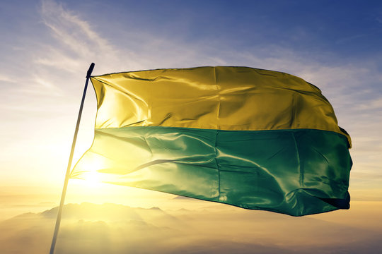 Vichada department of Colombia flag waving on the top sunrise mist fog