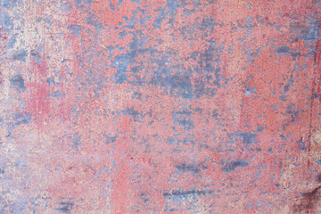 Old distressed red painted sheet iron wall grungy background or texture