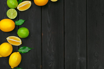 lemons and limes on a wooden background.