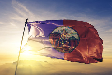 Buriram province of Thailand flag waving on the top sunrise mist fog