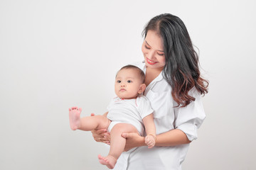 Motherhood and lifestyle concept. Smiling young mother with little baby at home