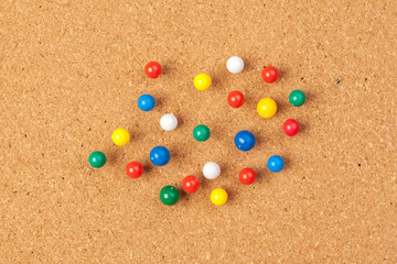 Group of thumbtacks pinned on corkboard