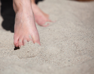Female feet in the sand