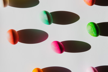 Overhead view of Easter eggs with shadows on white background