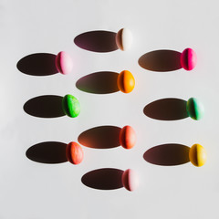 Overhead view of Easter eggs with shadows on white background