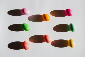 Overhead view of Easter eggs with shadows on white background