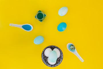 Blue and white easter eggs on yellow background
