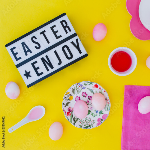 Easter eggs pink on yellow background