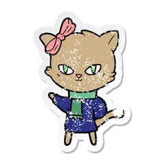 Obraz na płótnie Canvas distressed sticker of a cute cartoon cat in winter clothes