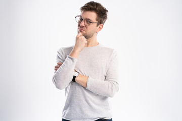 Photo of thoughtful man isolated over white background wall.