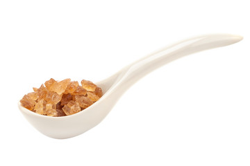 A porcelain spoon with rock sugar side view