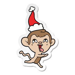 crazy sticker cartoon of a monkey running wearing santa hat