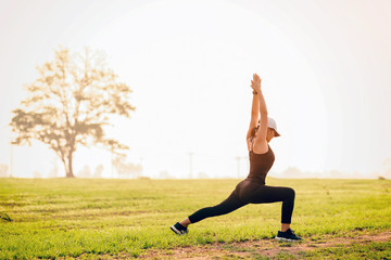 Runner athlete running at green area.Young woman doing yoga exercise yoga master pose Amazing yoga landscape in beautiful and enjoying view, fitness silhouette sunrise jogging workout wellness concept