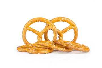 Group of five whole mini salted pretzels isolated on white background