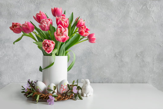 Bouquet of red tulip in vase on white vintage table. Space for text.
