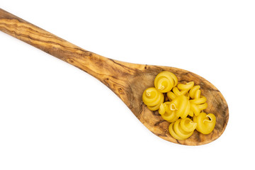 Lot of whole raw pasta funghetto variety in a wooden spoon flatlay isolated on white background