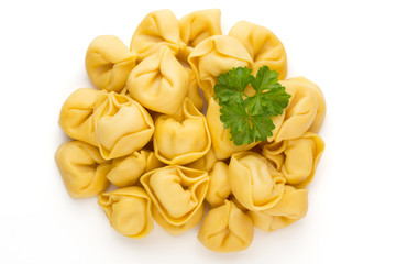 Raw homemade pasta,tortellini with herbs.